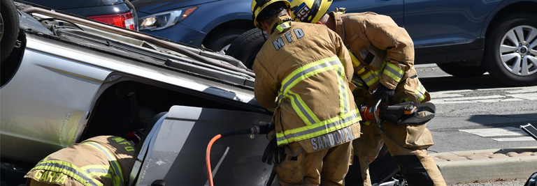 firefighters assisting at a car crash